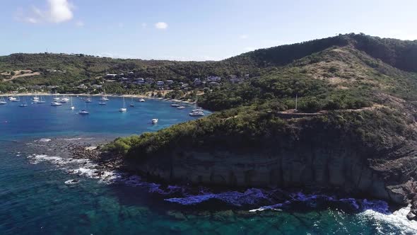 Aerial Drone Footage of Exotic Island Strip with Green Rock in Caribbean Ocean
