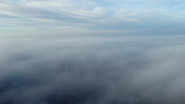 Aerial Drone View Flight Over Above Fog Mist and Roofs of Buildings in City alt