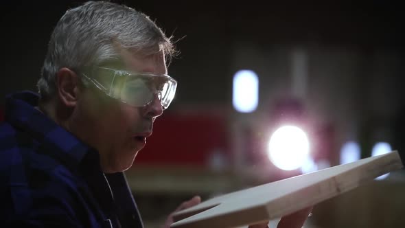 Carpenter at work in woodshop alt