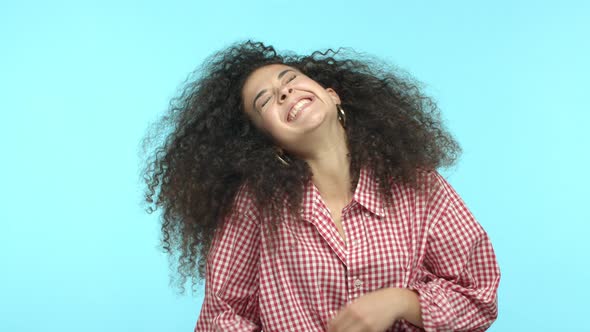 Slow Motion of Modern Beautiful Girl with Long Curly Hair Having Fun and Standing Joyful Over