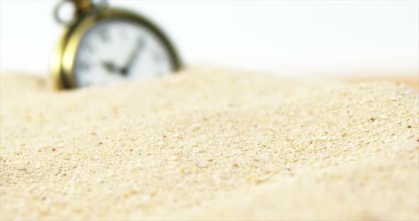 Alarm clock in sand alt