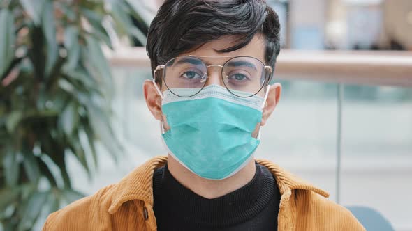 Portrait Closeup Young Indian Guy in Protective Medical Mask Standing Indoors Confident Man Posing alt