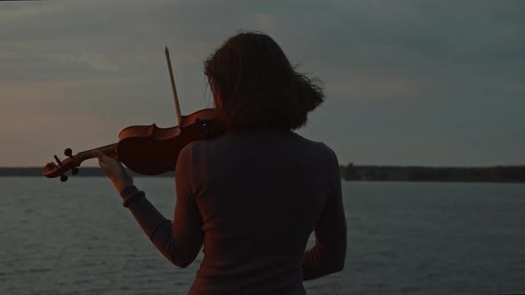 Woman Is Playing Violin On Sunrise