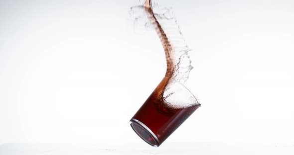 Glass Falling and Red Wine splashing against White Background, Slow Motion 4K