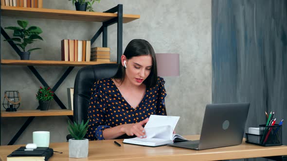 Student woman in home office search information in notebook looks laptop tells teacher, online study alt