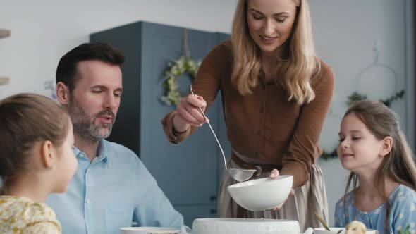 Caucasian family about to start an easter dinner at home. Shot with RED helium camera in 8K. alt
