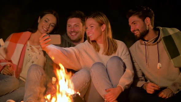 Friends Taking Selfie at Night Camp Fire alt