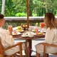 Young Couple Enjoying The Breakfast On The Terrace With The Jungle View In Bali, Indonesia - VideoHive Item for Sale