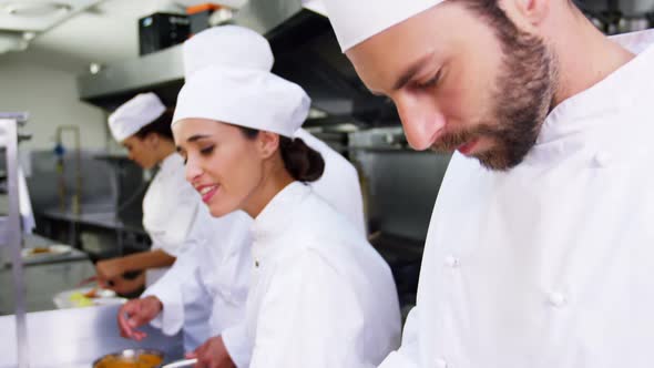 Team of chefs chopping vegetables and preparing food alt
