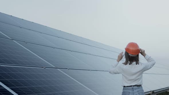 Inspector Engineer Woman Holding Digital Tablet Working in Solar Panels Power Farm alt