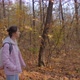 Side View of Young Woman with Backpack Walking in Autumn Park  Steadicam Shot - VideoHive Item for Sale