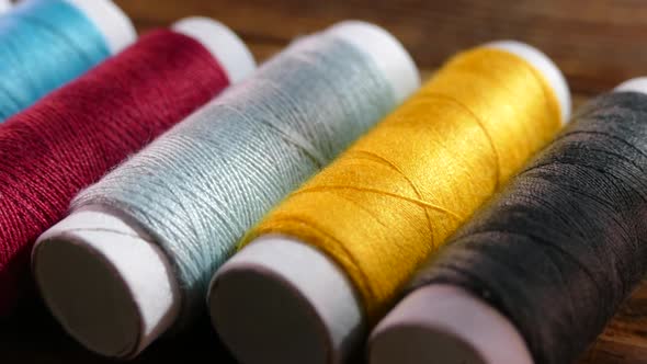 Spools of Colored Thread Close-up. Textile Industry. Sew with a Needle and Thread. Embroider on