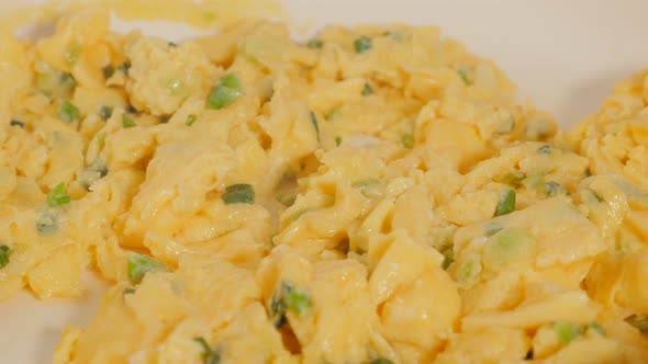 Ceramic pan on oil preparing scallion and omelet 4K 2160p 30fps UltraHD footage - Omelette scrambled alt