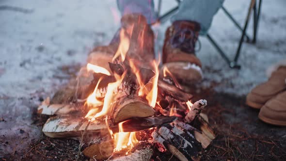 Close Shot of Roasting Sausages on Sticks on a Campfire in Winter