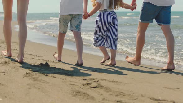 Close-up of bare feet walking in sand alt