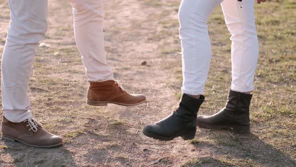 Couple Is Dancing Together Hitting Their Feet Outside alt