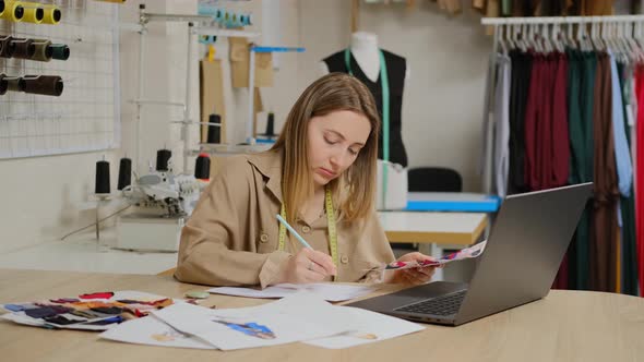 Close up of female designer is using her laptop computer working at the design studio alt