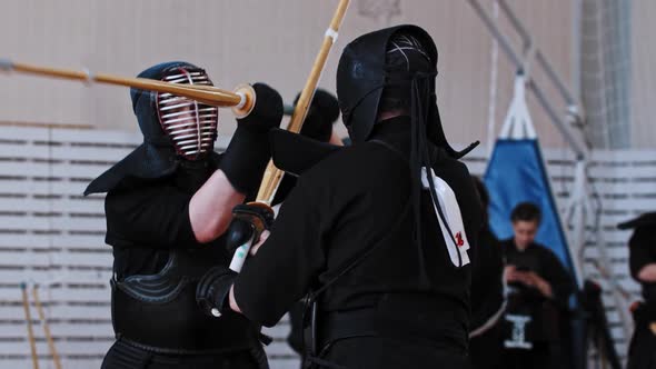 Kendo Tournament in the School Gym Two Men in Black Costumes Having a ...