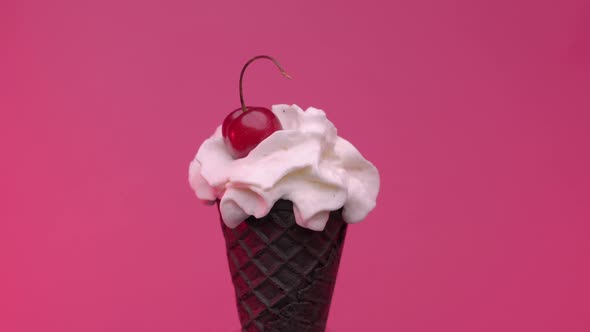 Soft Ice Cream in Black Cone Decorated with Cherry