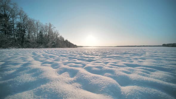 Cheerful Girls Run Across the Snowcovered Field alt