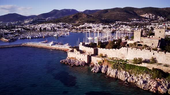 View from drone on full of yachts Bodrum harbour and ancient Kalesi castle in Mugla in Turkey alt