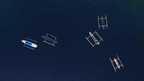 Beautiful Static Aerial Top View From Above of White Fishing Boats on Clear Blue Ocean Water