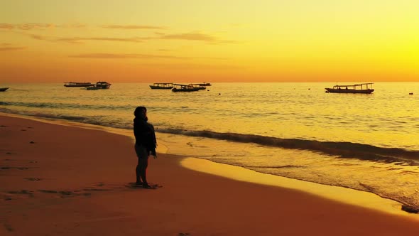 Girl sunbathes on exotic seashore beach voyage by shallow lagoon and bright sandy background of the  alt