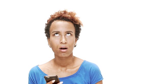 Displeased Young Beautiful African Girl Looking at Phone Over White Background alt