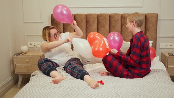 Two Women in Love and Fight with Balloons in Bed alt