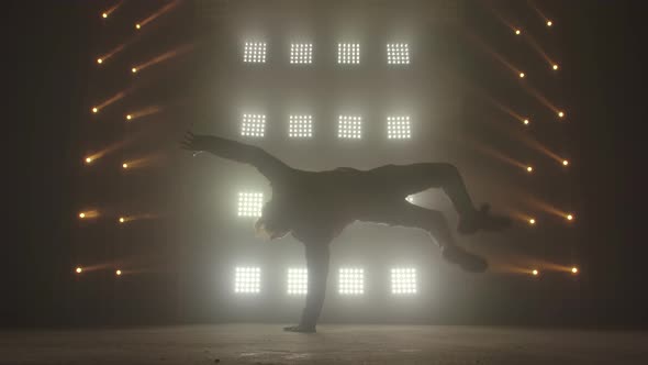 Breakdance Concept. Trendy Young Man Dancing Single in Club, Neon Light, Lots of Smoke. Fashion alt