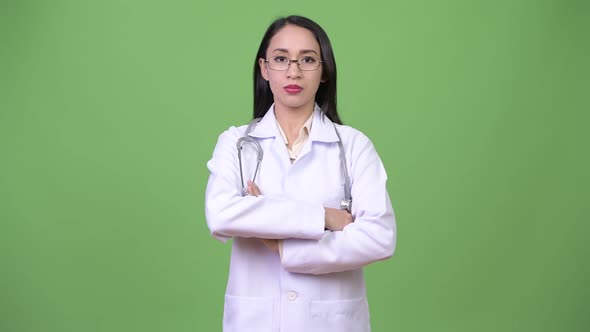 Young Beautiful Asian Woman Doctor Smiling with Arms Crossed alt