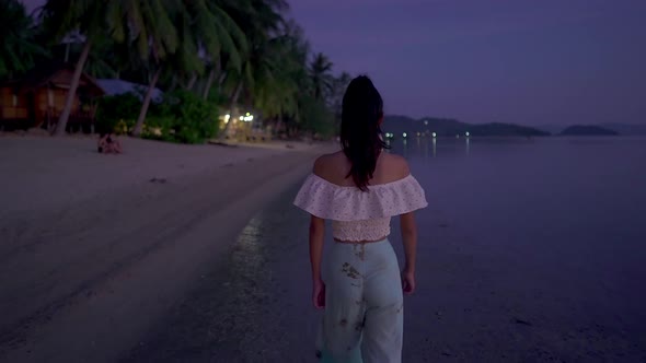 Young Woman Walking Alone on the Beach at Sunset Thailand
