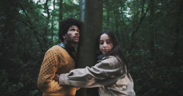 Man and woman hug with tree in the middle alt