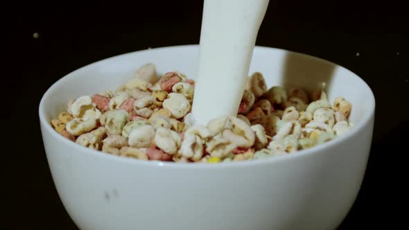 Milk being poured into bowl of puffed wheat cereals, Ultra Slow Motion alt