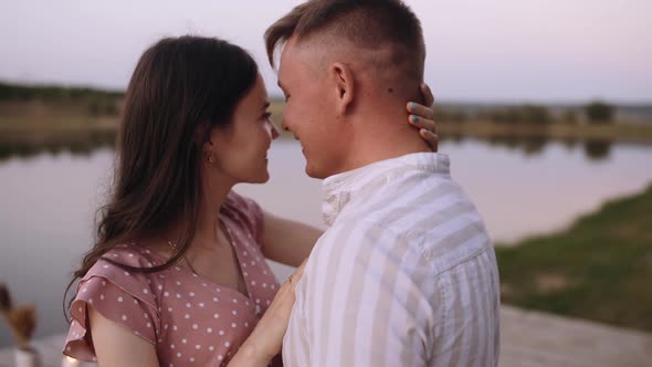 Close-up of a Couple in Love Standing Face To Face and Looking Into Each Other's Eyes alt