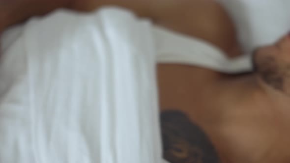 People Bedtime and Rest Concept  Close Up of Man with Smartwatch Sleeping in Bed alt