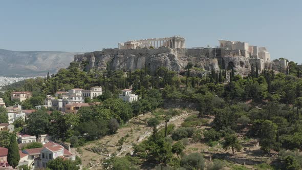 Slow Aerial Dolly Towards Mountain with Acropolis of Athens in Greece at Daylight alt