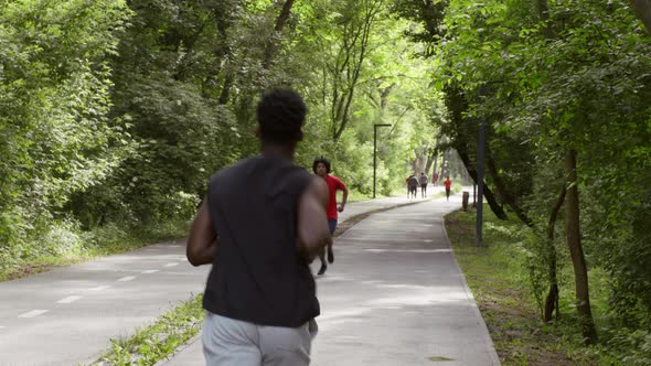 African American Man Jogging In City Park In The Morning alt
