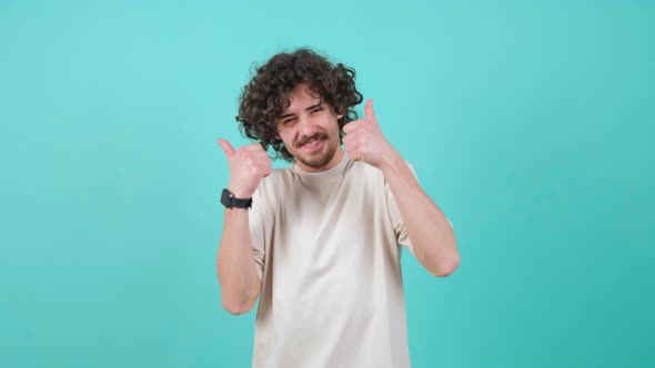 Satisfied Bearded Man with Curly Hair Doing Thumbs Up Gesture alt