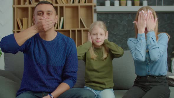 Positive Family with Kid Gesturing Different Communication Disabilities Indoors alt