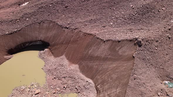 A Moraine Lake Among a Glacier Covered with Rocks alt