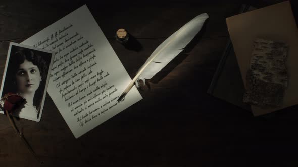 Handwritten letter with quill and extinguished candle
