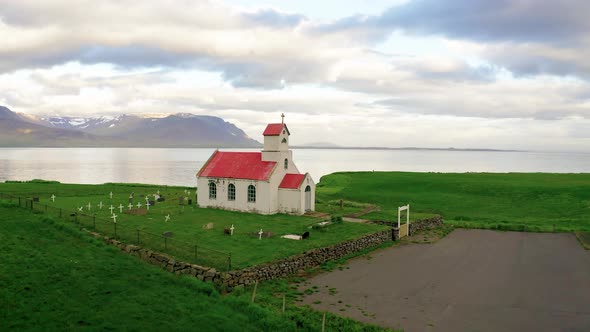 Flying Around InnraHolmskirkja Church with a Cemetery in Iceland alt