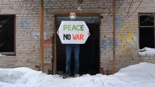 Man Holds Banner with Inscription Peace No War alt
