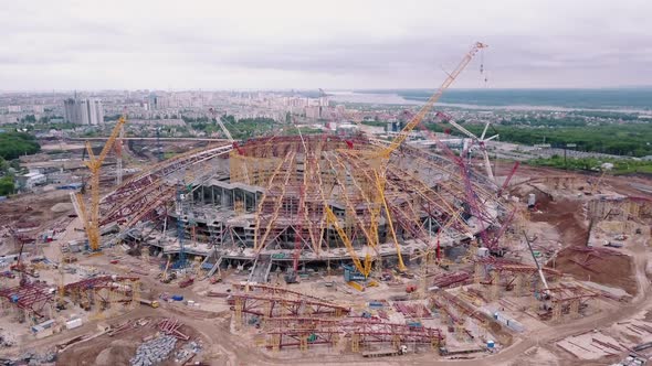 Cranes Are Standing Around New Modern Construction of the Stadium, Aerial View
