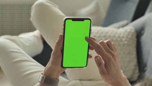 Mock Up Green Panel for Ads on Mobile Phone Screen in Hands of Lying Woman