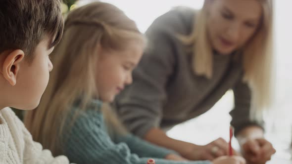 Video of children writing a letter to Santa Claus. Shot with RED helium camera in 8K. alt