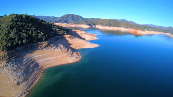 Shasta Lake Water Reservoir Aerial View Showing Low Water Levels During Drought alt