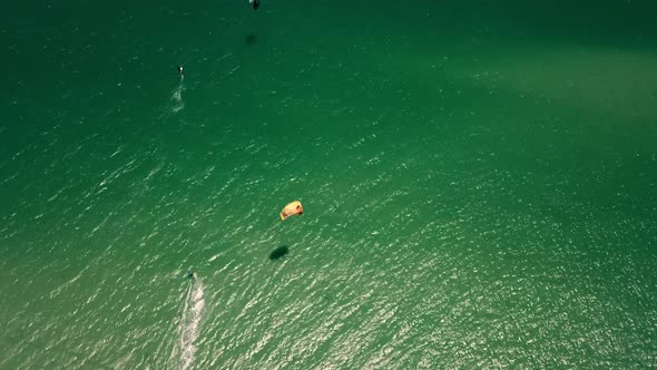high altitude top down drone shot of Kite surfer in turquise Atlantic ocean. perfect sunny weather i alt