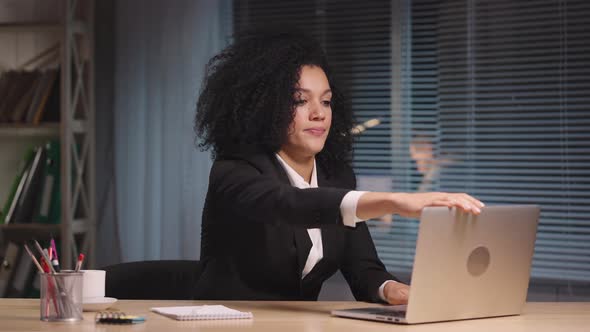 Portrait of African American Woman Finishes Work Closes the Laptop and Leaves alt